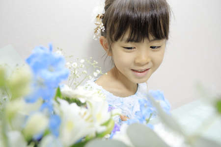 Japanese girl in a dress with bouquet (7 years old)の写真素材