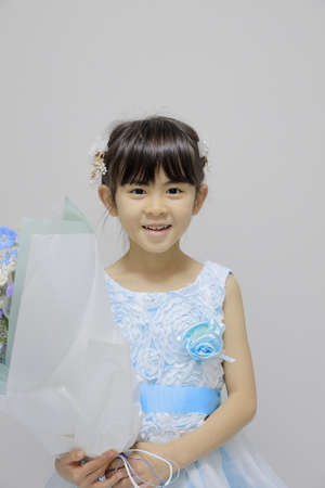 Japanese girl in a dress with bouquet (7 years old)の写真素材