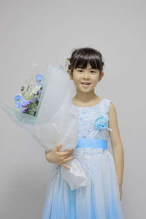 Japanese girl in a dress with bouquet (7 years old)の写真素材
