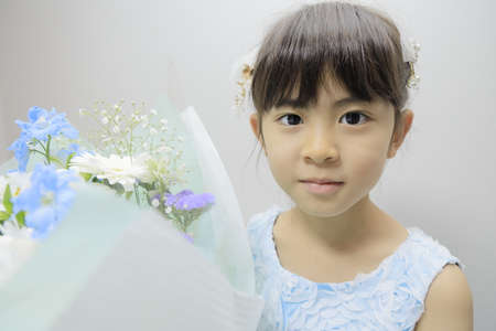 Japanese girl in a dress with bouquet (7 years old)の写真素材