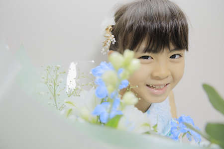 Japanese girl in a dress with bouquet (7 years old)の写真素材