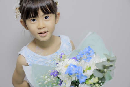 Japanese girl in a dress with bouquet (7 years old)の写真素材