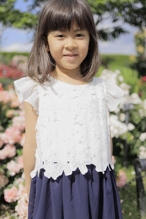 Japanese girl in flower garden (7 years old)の写真素材