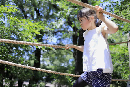 Japanese student girl playing with rope walking (7 years old)の写真素材