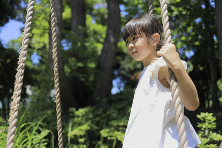 Japanese student girl playing with rope walking (7 years old)の写真素材