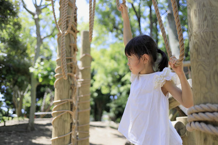 Japanese student girl playing with rope walking (7 years old)の写真素材