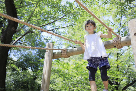 Japanese student girl playing with rope walking (7 years old)の写真素材