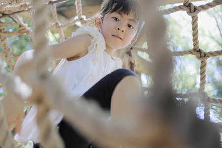Japanese student girl playing with rope walking (7 years old)の写真素材