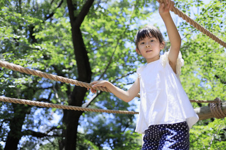 Japanese student girl playing with rope walking (7 years old)の写真素材