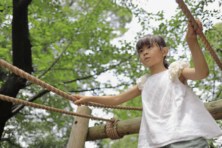 Japanese student girl playing with rope walking (7 years old)の写真素材