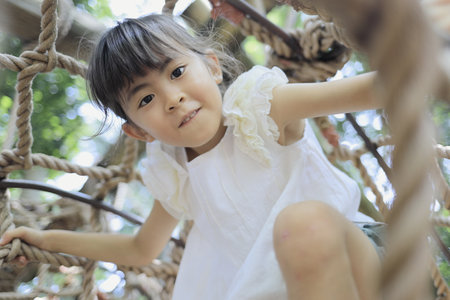 Japanese student girl playing with rope walking (7 years old)の写真素材