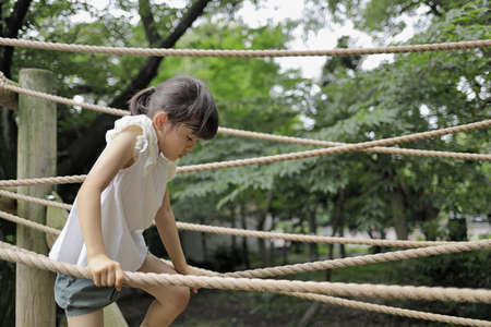 Japanese student girl playing with rope walking (7 years old)の写真素材