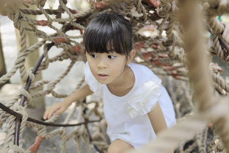 Japanese student girl playing with rope walking (7 years old)の写真素材