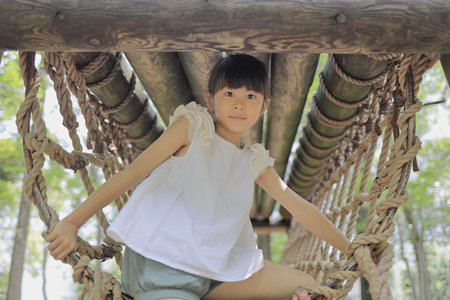 Japanese student girl playing with rope walking (7 years old)の写真素材