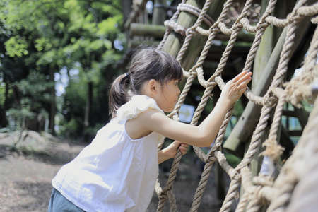 Japanese student girl playing with rope walking (7 years old)の写真素材