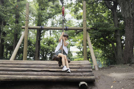 Japanese student girl playing with flying fox (7 years old)の写真素材