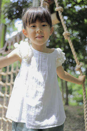 Japanese student girl playing with rope walking (7 years old)の写真素材