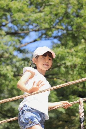 Japanese student girl playing with rope walking (7 years old)の写真素材