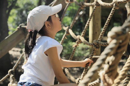 Japanese student girl playing with rope walking (7 years old)の写真素材