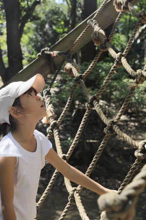 Japanese student girl playing with rope walking (7 years old)の写真素材