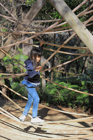 Japanese student girl playing with rope walking (8 years old)の写真素材