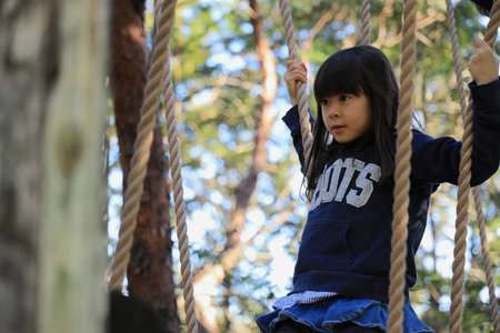Japanese student girl playing with rope walking (8 years old)の写真素材