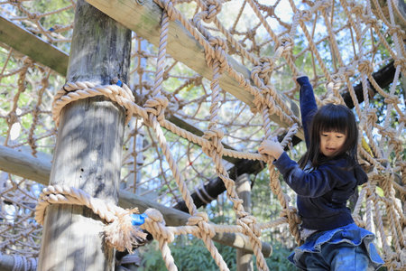 Japanese student girl playing with rope walking (8 years old)の写真素材