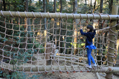 Japanese student girl playing with rope walking (8 years old)の写真素材