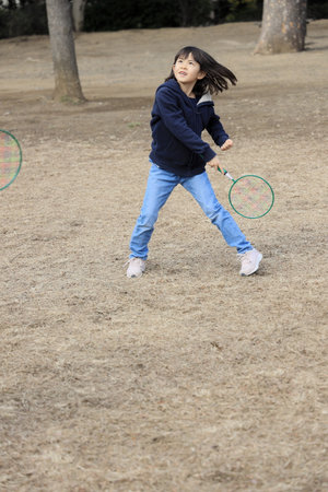 Japanese student girl playing badminton (8 years old)の写真素材