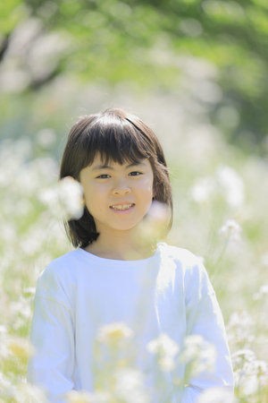 Japanese student girl in flower garden (8 years old)