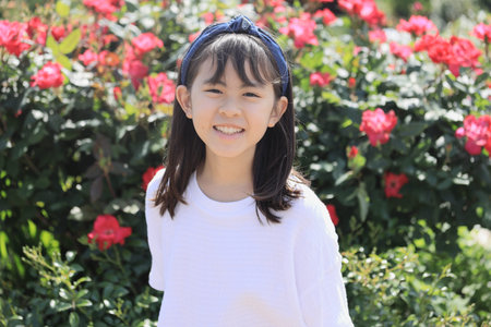 Japanese student girl in rose garden (10 years old)