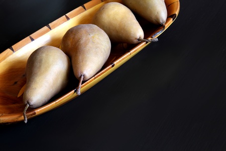 pears in exotic wood bowlの写真素材