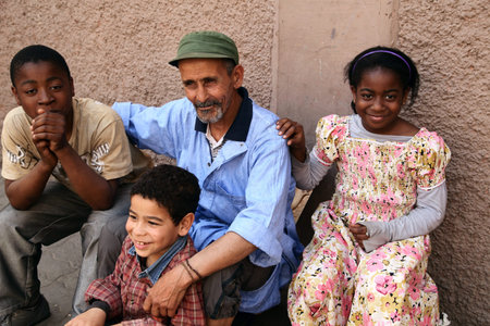 MARRAKESH, MOROCCO-APRIL 29, 2013:A father and his children beg for money or gifts in difficult economic times in Marrakesh, Morocco on April 29, 2013.のeditorial素材