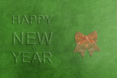 Green Template of a New Year postcard on a background of a genuine leather