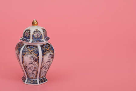 Classic oriental vase with jasmine branch isolated on pink (coral) backgroundの写真素材