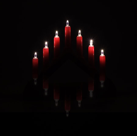 Mockup: Red Christmas candlestick isolated on black background