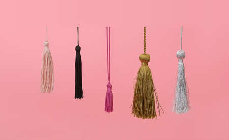 Multicolour silk tassels isolated on pink backgroundの写真素材