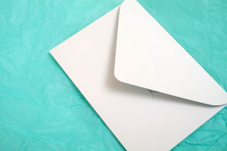 Romantic composition with white envelopes on a turquoise background