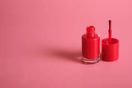Nail polishes bottle isolated on pink backgroundの写真素材