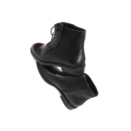 Fashionable black boots for men and women isolated on white background
