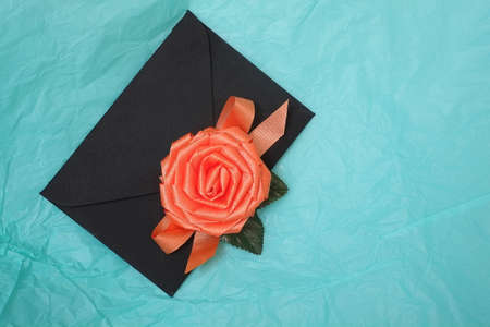 Romantic composition with black envelopes on a turquoise backgroundの写真素材
