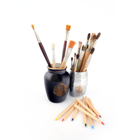 Brushes of an artist in a vase isolated on a white backgroundの写真素材