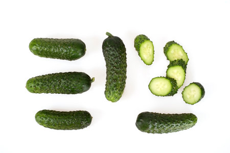 Fresh green cucumbers isolated on white background (top view)の写真素材