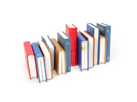 Stack of books in color covers with white sheets isolated on a white background