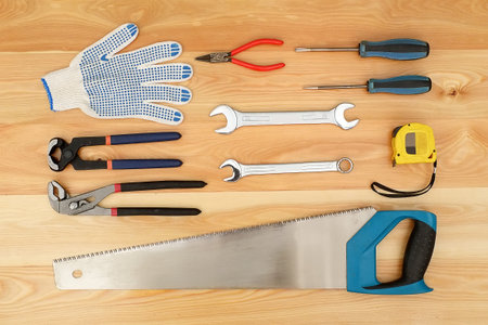 Various tools for handmade isolated on a wooden board