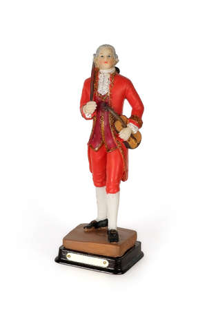 Souvenir figure of the old Austrian musician with a violin isolated on a white backgroundの写真素材