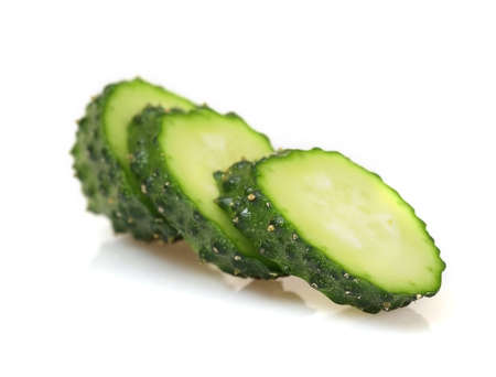 Fresh green sliced cucumber isolated on white backgroundの写真素材