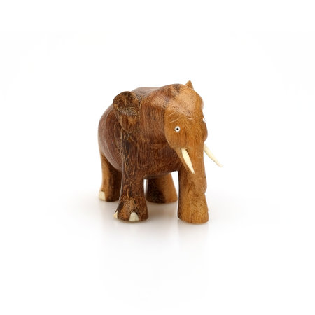 Wooden souvenir elephant made of wood and ivory isolated on a white backgroundの写真素材