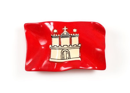 Souvenir from Hamburg (Germany) with the image of the flag with the emblem of the city isolated on white background.の写真素材