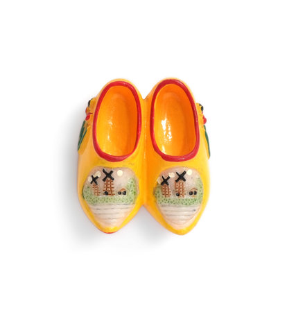 Magnetic souvenir from Netherlands (Holland) in the form of wooden clogs isolated on white...